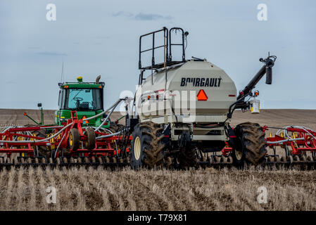 Swift Current, SK/Canada- May 4, 2019: Tractor and air drill seeding equipment in the field in Saskatchewan, Canada Stock Photo