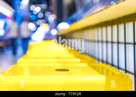 yellow steel chair arranged on the front of a counter at a restaurant bar. Stock Photo