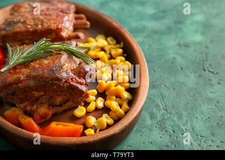 Plate with delicious grilled ribs and corn seeds on table Stock Photo