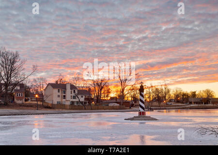 Mackerel sky during sunrise over a replica lighthouse in the lake at Ferguson's January-Wabash Park in St. Louis County on a winter morning. Stock Photo