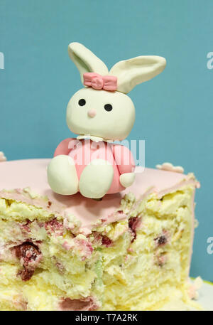 Sweet hare statuette on a piece of cake for the birthday Stock Photo