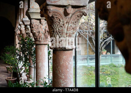 A closed up view of stone pillars and capitals with grotesques.The Cuxa Cloister.The Met Cloister.Metropolitan Museum of Art. New York City.USA Stock Photo