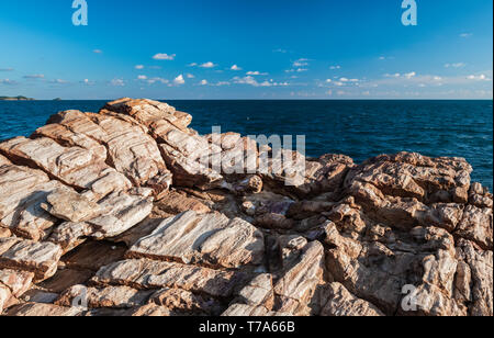 Texture of strange boulder rocks dark nook and warm color with sun lighting. Stock Photo
