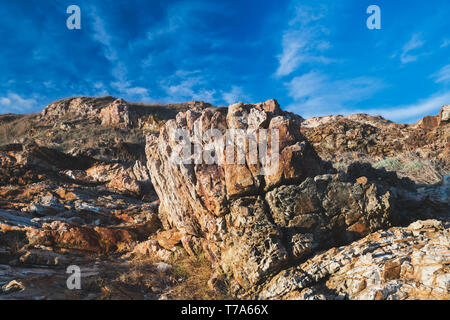 Texture of strange boulder rocks dark nook and warm color with sun lighting. Stock Photo