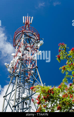 Communications tower. Transmitter station detail. Antennas. Blue sky. Steel truss construction. Microwave signal transmission equipment. Wireless wifi. Stock Photo