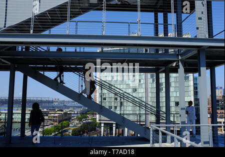 Visitors on staircase of outdoor terrace of Whitney Museum of America Art with the Standard Hotel in Meatpacking district in background.New York City. Stock Photo