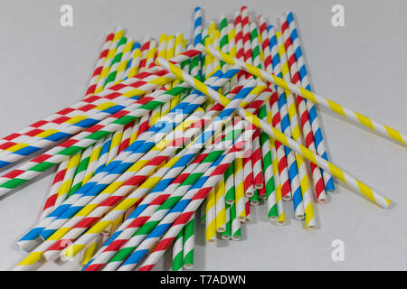 Jumbled assortment of colourful paper straws, single use plastic alternative, against climate change/pollution, isolated on white background Stock Photo