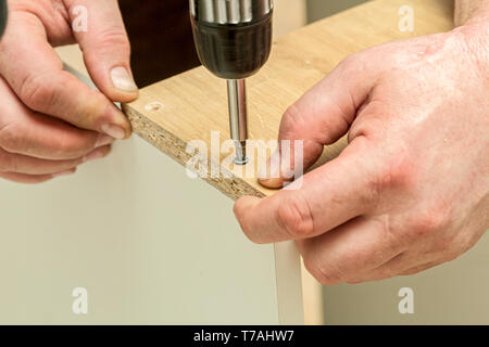 The process of furniture assembly screws closeup Stock Photo