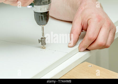 Close-up image of drilling hole on wooden plank Stock Photo