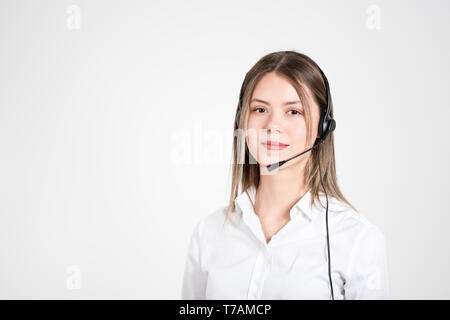 Female consulting manager with headset on light background Stock Photo