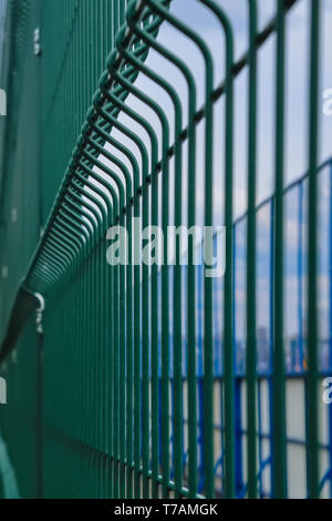 Metallic fence around the hockey court. Fence metal green color for protect hockey court texture background. Stock Photo