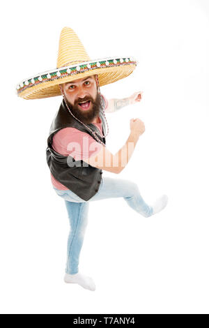 Mexican energetic temper. Man bearded cheerful guy wear sombrero mexican hat. Mexican party concept. Celebrate traditional mexican holiday. Guy happy cheerful face having fun dancing and jumping. Stock Photo