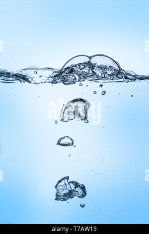 Group of unterwater bubbles rising in clear fresh water on gradient blue background Stock Photo