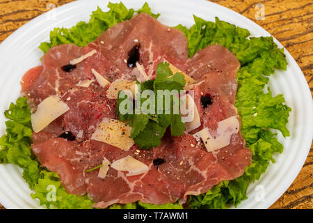 Beef carpaccio with parmesan cheese and salad leaves Stock Photo