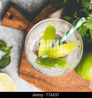 Lemonade or Mojito cocktail with lime in glass. Top view, square crop Stock Photo