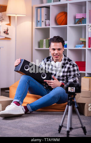 Attentive professional reviewer sitting in front of camera Stock Photo