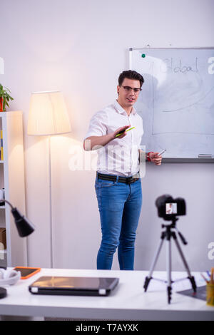 Professional educative blogger wearing blue jeans and white shirt Stock Photo