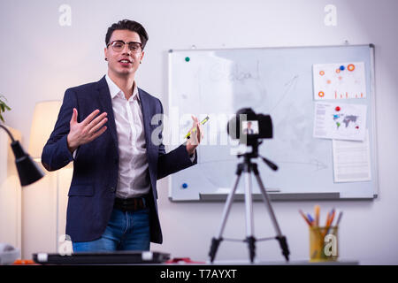 Expressive man in black neat jacket actively gesturing Stock Photo