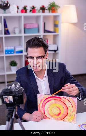 Focused online teacher creating video content on his channel Stock Photo
