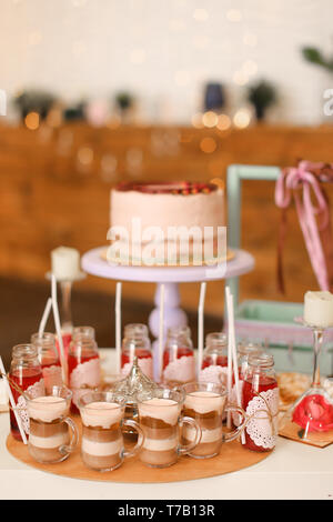 Tasty birthday big cake and yummy drinks on table. Stock Photo
