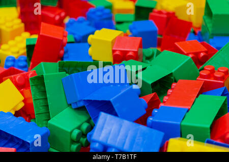 Multicolored plastic building blocks. Background of bright plastic building blocks Stock Photo