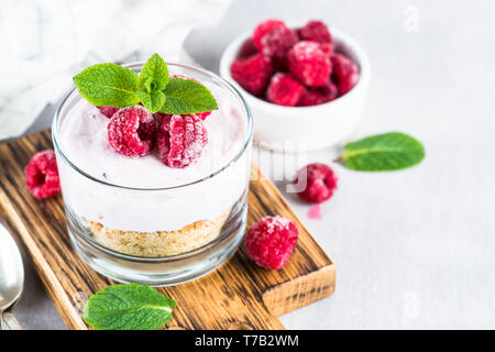 No baked cheesecake with raspberry in glass jar. Stock Photo