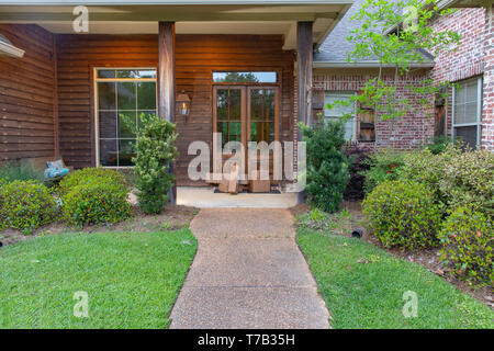 Boxes of mail on porch doorstep in front of house. Stock Photo