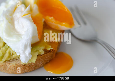 Avocado Sandwich with Pushing Egg  - Puree avocado and egg on  sliced bread for healthy breakfast or snack Stock Photo