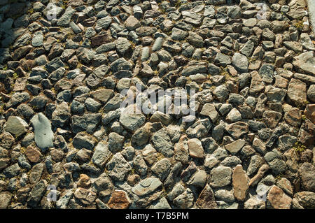 Close-up of rough stone pavement in a pathway, forming a singular background at Marvao. A medieval hamlet perched on a crag in Portugal. Stock Photo