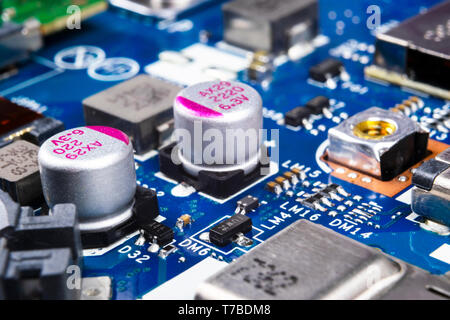 Macro shot of Circuit board with resistors microchips and electronic components. Computer hardware technology. Integrated communication processor. Inf Stock Photo