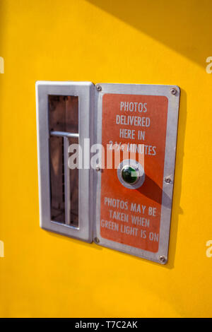 Green Light on a Vintage Yellow Photobooth Stock Photo