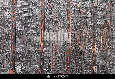Texture of burnt wooden boards. Damaged burned hardwood surface Stock Photo