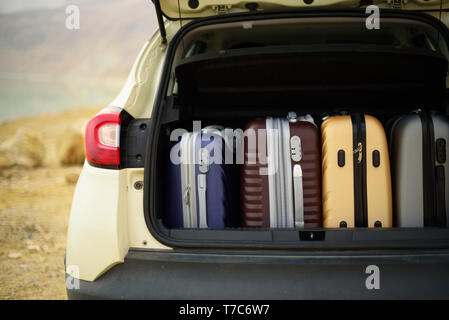 Opened car trunk full of suitcases, luggage, baggage. Summer holidays, travel, trip, adventure concept Stock Photo