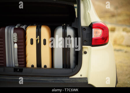 Opened car trunk full of suitcases, luggage, baggage. Summer holidays, travel, trip, adventure concept Stock Photo