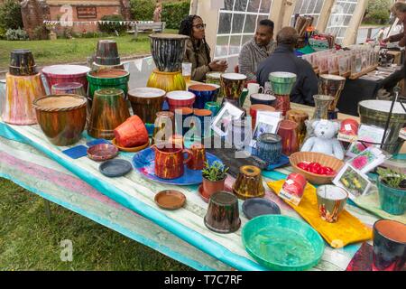 Colourful painted ceramics or pottery items for sale on a stall at a village may fayre in Oakhanger, Hampshire, UK Stock Photo