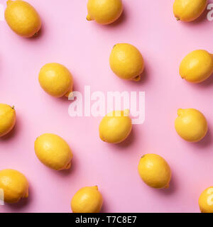 Food pattern with lemons on pink paper background. Top view. Summer concept. Vegan and vegetarian diet. Square crop. Stock Photo
