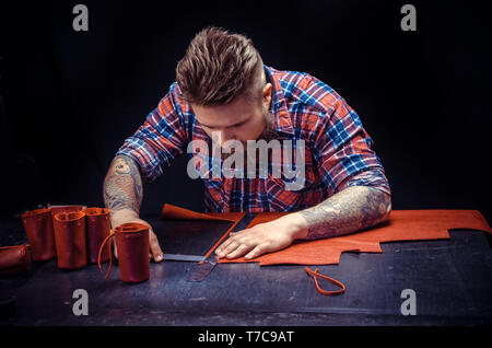 Leather Artist making quality products at his shop Stock Photo