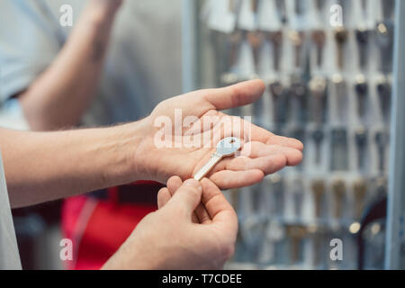 Locksmith with key blanks in his shop Stock Photo