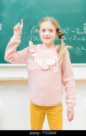 Genius schoolgirl could solve the math task Stock Photo