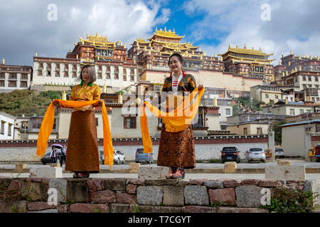 Songzanlin Tibetan Buddhist Monastery reflected in sacred lake, Shangri-La, Yunnan Province, China Stock Photo