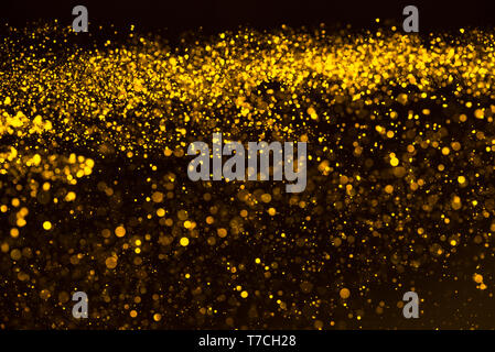 Gold confetti glitter dust rain abstract background Stock Photo