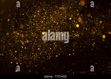 Magic glowing gold dust particles flowing abstract background