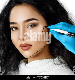 Beautiful woman face with correction lines. Stock Photo