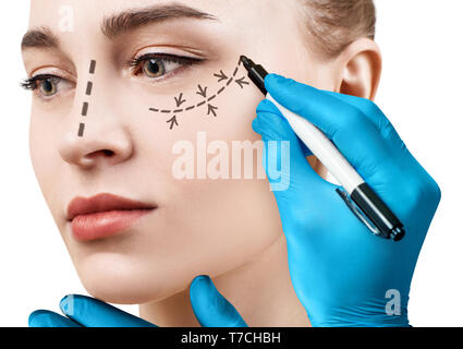 Beautiful woman face with correction lines. Stock Photo