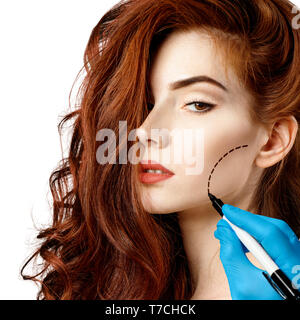 Beautiful woman face with correction lines. Stock Photo