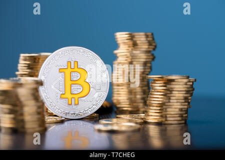 Bitcoin coin between coins stacks Stock Photo