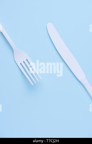 White new clean knife and fork on blue trendy pastel background Stock Photo