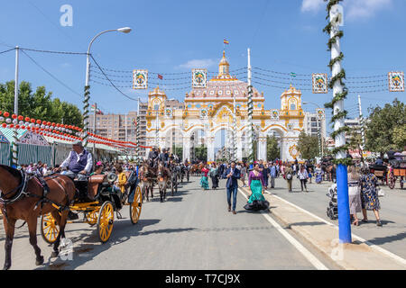 Seville, Spain - May 5, 2019: People entering in the April Fair through of main door of the Fair of Seville on May, 5, 2019 in Seville, Spain Stock Photo