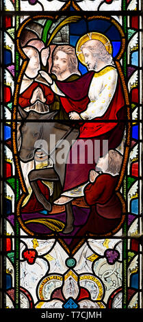 Stained glass window Jesus Christ entering Jerusalem on a donkey, circa 1870 by Ward and Hughes, church of Saint Andrew, Bramfield, Suffolk, England,  Stock Photo