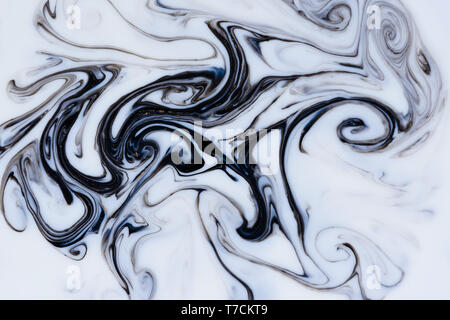 Fluid dark black and gold dust flowing marble abstract background Stock Photo